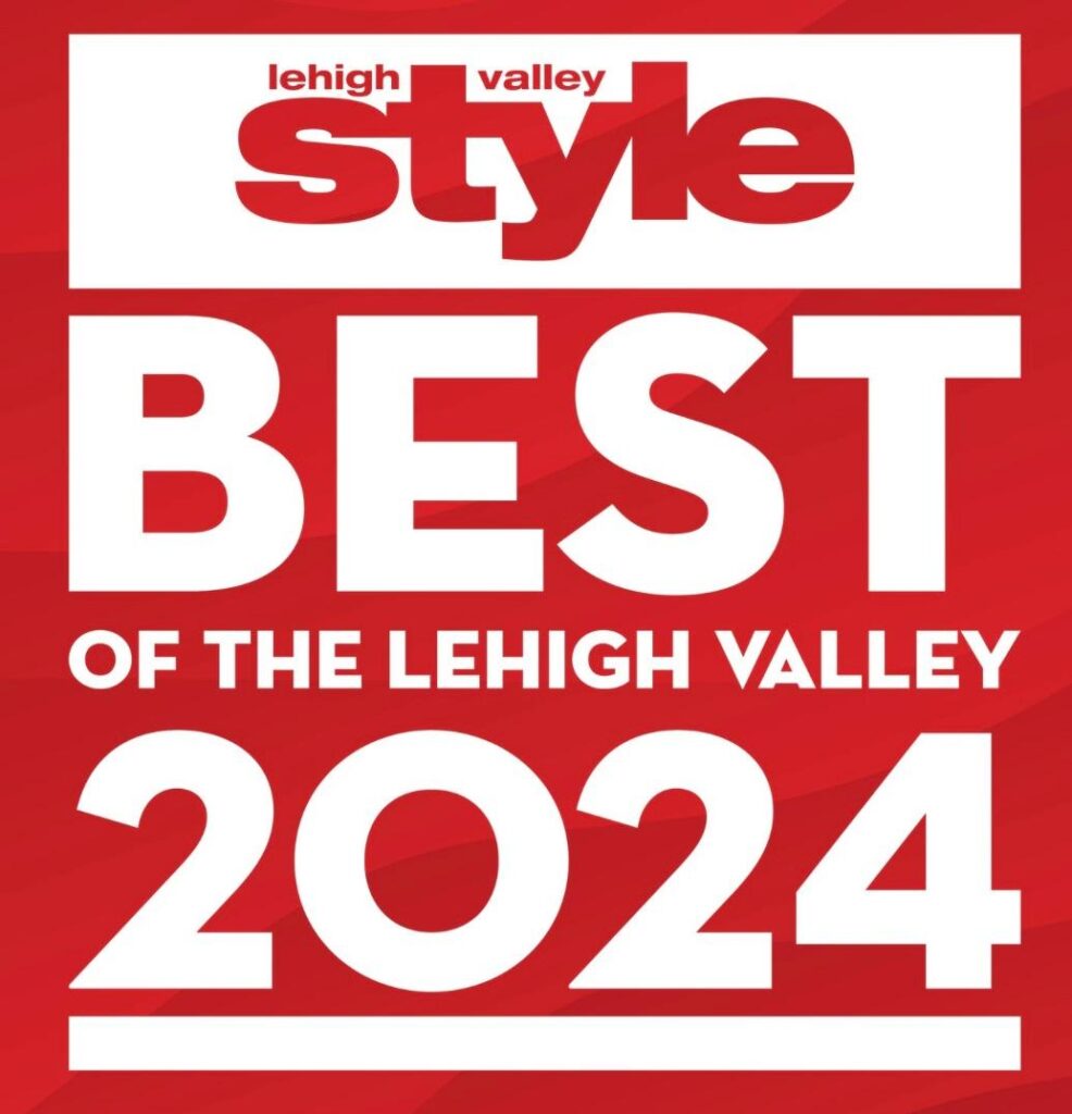 Silhouette of a person meditating in lotus pose against teal background.