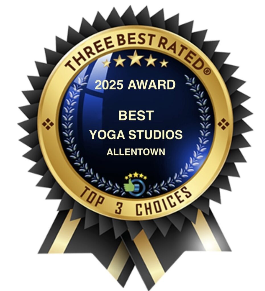 Silhouette of a person meditating in lotus pose against teal background.